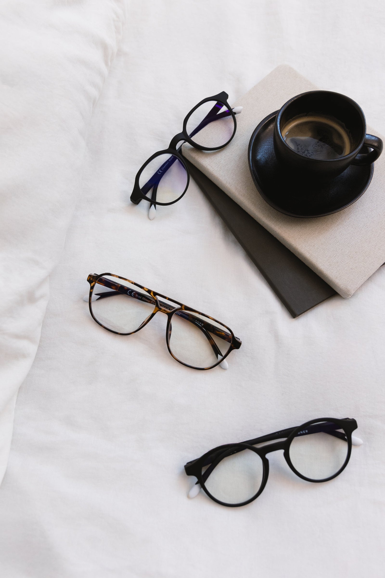 Reading glasses lying on a bed