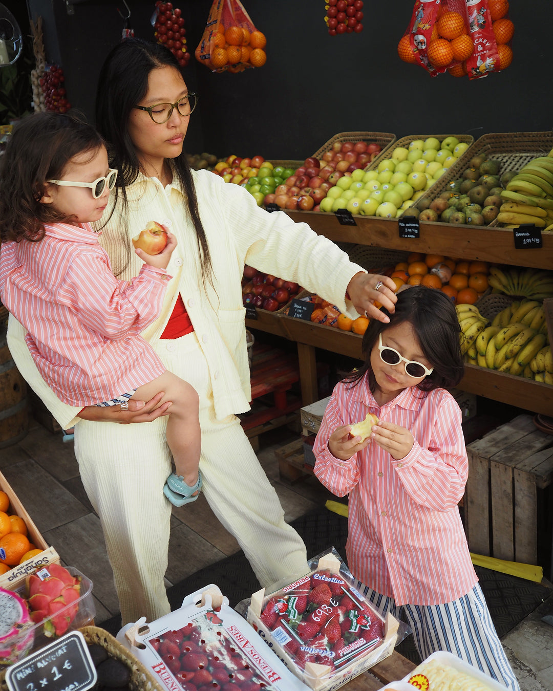 Kids wearing sunglasses while shopping with their mother